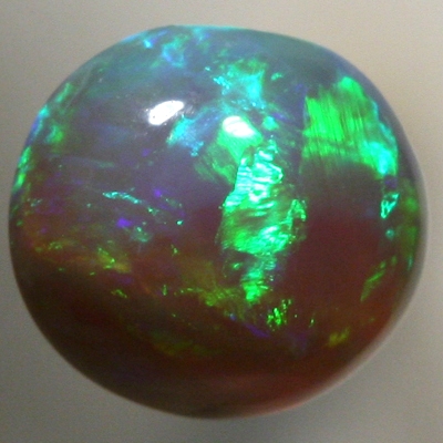SOLID BLACK CRYSTAL OPAL Bright greens rolling flashes over a high dome